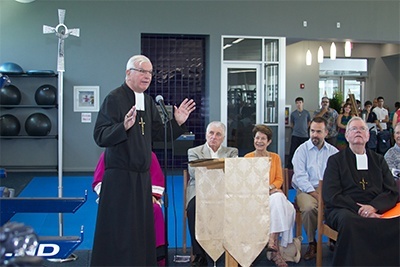 Marist Brother Kevin Handibode, president of Christopher Columbus High School, speaks to those in attendance at the blessing of the school's new All Sports Fitness Complex & Bernhardt Wellness Center.