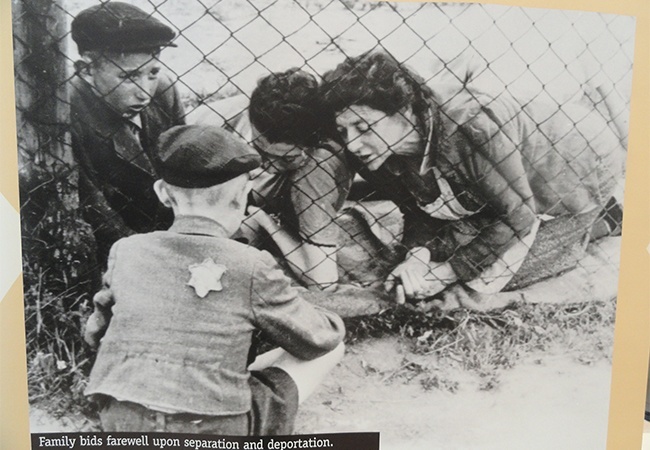 The exhibit uses images taken during the Holocaust and the killing of Jews in Eastern European ghettos.