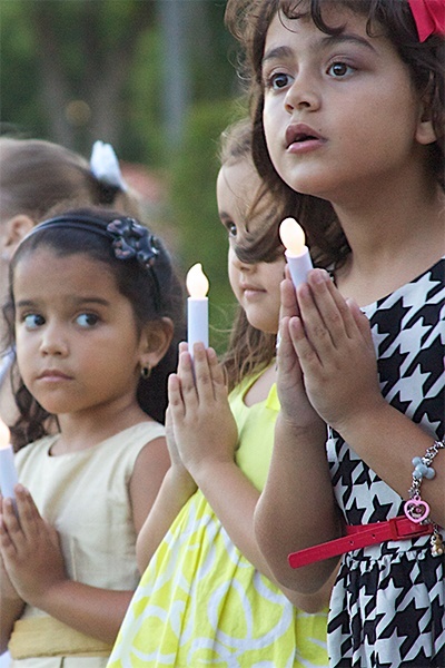 Blessed Trinity School children light the path for the procession that led from Blessed Trinity Church to the newly dedicated Father Joseph T. Carney Enrichment Center. From left are first grade students Karina Martinez, Leah McGregor and Giovanna Khoury.