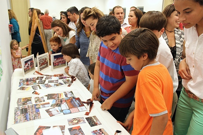 Current and former Blessed Trinity School students as well as parishioners visit the historical exhibit that recapped the parish's 60 years. The display was housed in the newly blessed Father Joseph T. Carney Enrichment Center.