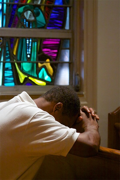 An Emmaus brother prays during the solemn Mass marking the 35th anniversary of the retreat.