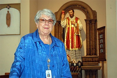 Sister Vivian Gomez wants someday to write a book on St. Philip Neri, her order's founder, whose statue is shown here in the sanctuary at St. Jerome.