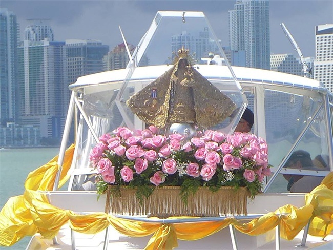 The pilgrim image of Our Lady of Charity is outlined against the Miami sky as she makes her way through Biscayne Bay blessing the city and its residents.