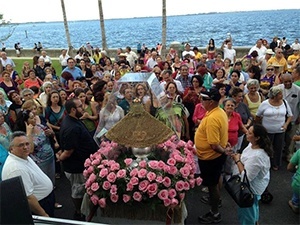 The faithful sing to the image of the virgin after her arrival at the Shrine of Our Lady of Charity.