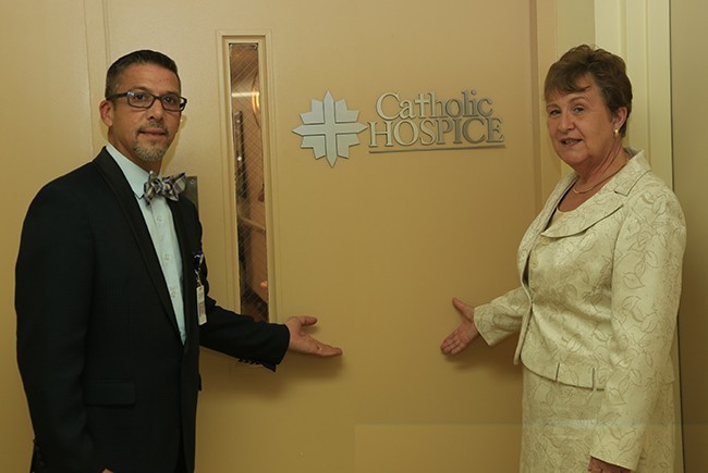 Ricardo Pol, director of Professional Services, and Bonnie Alkema, executive director of Catholic Hospice, stand at the entrance of the new Inpatient Unit at St. Anne's.