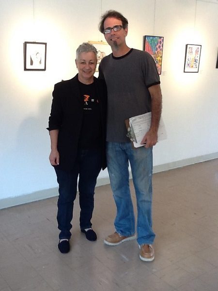 Professional artist Gerry Stecca, right, has volunteered for the past three years as jurist for Archbishop Curley Notre Dame's Middle School Art Festival. Miami art professionals provide a written evaluation of each participant's art piece as well as words to encourage each student to continue to develop his/her skills. With him above is Caryne Havican-Mender, ACND Gallery Curator.