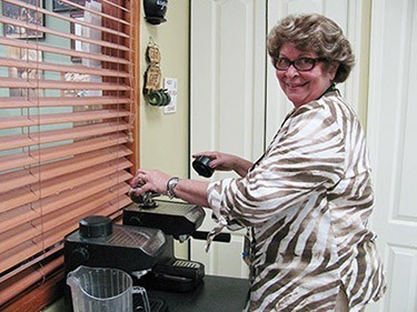 Celia Cabrera, better known as “Celita,” makes Cuban coffee for
her ninth-grade class at Msgr. Edward Pace High School.