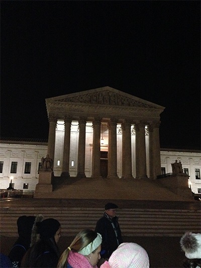 Braving frigid temperatures, high school students from the Archdiocese of Miami take part in an evening prayer vigil in front of the Supreme Court.