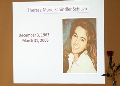 As Bobby Schindler spoke, this photo of his late sister, Terri Schiavo, taken before she sustained a brain injury, was projected on the screen behind him.