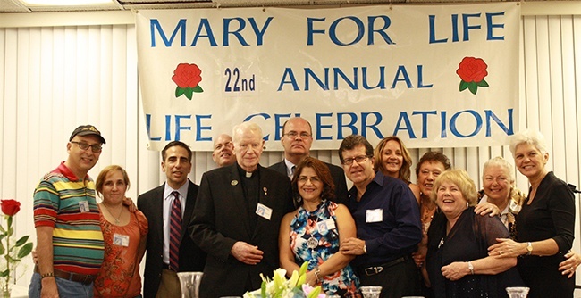 Bobby Schindler, third from left, executive director of Terri Schiavo Life & Hope Network, poses with St. Malachy's pastor, Father Dominic O'Dwyer, and members of the parish's pro-life ministry, Mary for Life.