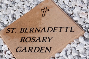 Sign marking the new rosary garden at St. Bernadette Church.