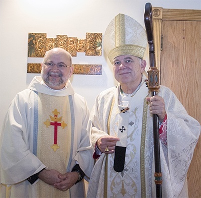 Father Pedro Toledo poses with Archbishop Thomas Wenski after his ordination.