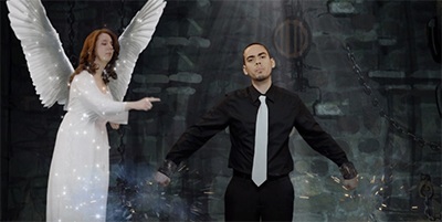 Alvaro Vega is freed from chains by an angel, played by Nicole Colom, in his video "I Believe."