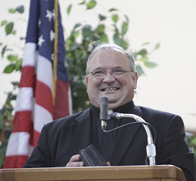 Miami's auxiliary bishop-elect, Msgr. Peter Baldacchino, 53, smiles broadly after making his statement during the press conference where his appointment was announced.