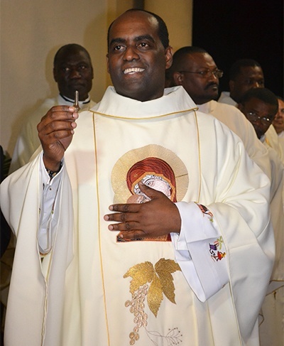 Father Reginald Jean-Mary shows the keys to the new church at the start of the Mass of dedication.