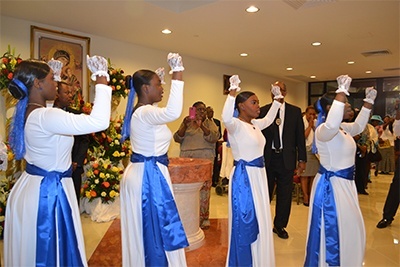 Young parishioners process into church in typically rhythmic Haitian style.