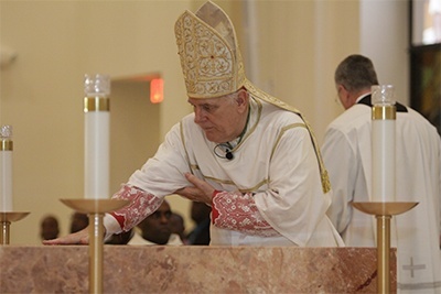 Archbishop Thomas Wenski rubs the oil of chrism on the altar of Notre Dame d'Haiti Church.