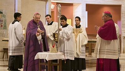 Archbishop Thomas Wenski blesses the insignia of Bishop-elect Peter Baldacchino: ring, miter and crosier.