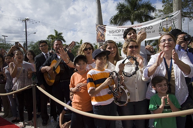 Members of the Neocatechumenal Way sang songs and hung banners in the plaza in front of the cathedral to welcome Bishop Peter Baldacchino to Miami. There are 30 Neocatechumenal communities in the archdiocese, active in eight parishes.