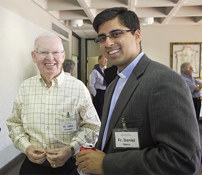 Father Daniel Martin, right, ordained in May 2013, poses with Father John McLaughlin, who handles the ministry to retired priests.