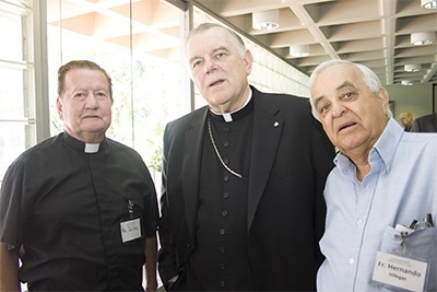 Archbishop Thomas Wenski poses with retired priests Father Jairo Tellez, left, and Father Hernando Villegas.