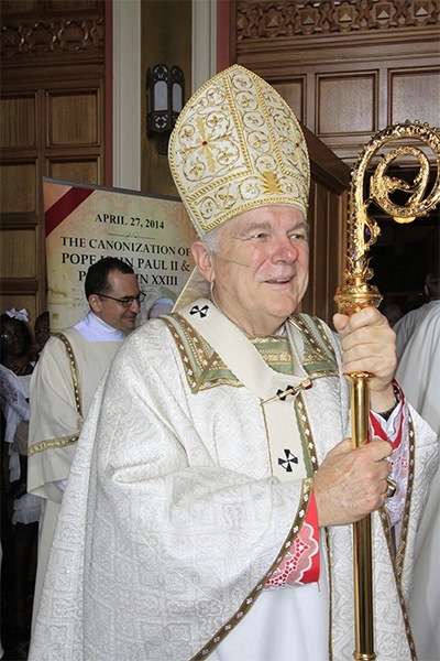 Archbishop Thomas Wenski greets archdiocesan priests as they process into St. Mary Cathedral.