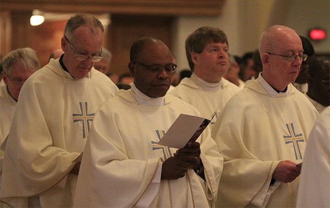 Archdiocesan priests renew their priestly promises at the chrism Mass.