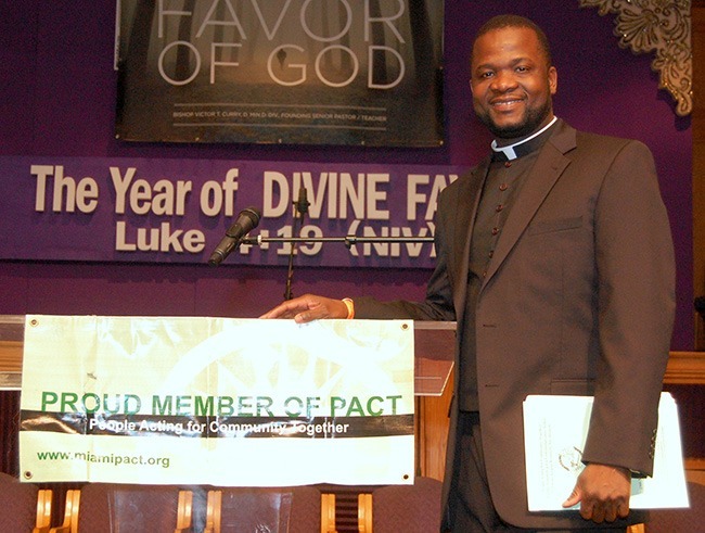 Msgr. Chanel Jeanty, vicar general of the Archdiocese of Miami, stands at the pulpit of PACT's Nehemiah Action Assembly.