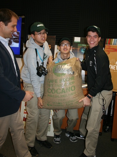 McCarthy students carry a ready for market 100-pound bag of Café Cocano.