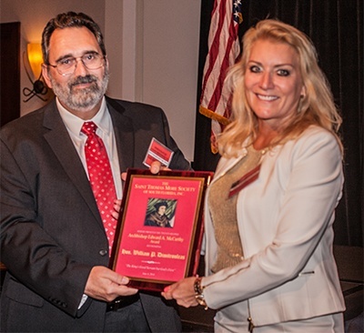 St.Thomas More Society President Cynthia Imperato presents the Archbishop Edward A. McCarthy award to Judge William Dimitrouleas.