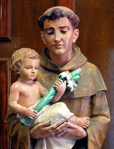 Statue of Anthony, in the lobby of St. Anthony School, has him in a typical pose holding the Christ Child and lilies. One story says that the infant Jesus appeared to Anthony just before the saint died.