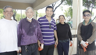 Father Joseph Long Nguyen poses with some of the two dozen volunteers who have helped prepare the old St. Charles Borromeo Church for its reopening as Our Lady of La Vang Vietnamese Mission. From left: Thuc Nguyen, Khoi Nguyen, Van Nguyen and Francis Van. Except for the Vans, who are brother and sister, none are related. Nguyen is a very common surname in Vietnam. Most of the volunteers are retired, Father Nguyen observed: "They don't want to stay home. They want to get exercise and help."