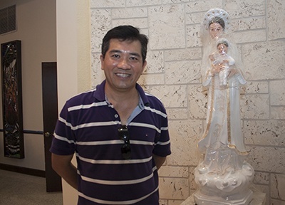 Father Joseph Long Nguyen stands next to an image of Our Lady of La Vang, venerated by the Vietnamese, which already has a place at the mission named after her.