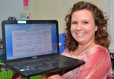 Sheila Pamplin shows the Spelling Tic-Tac-Toe system that St. Helen School uses with its students.