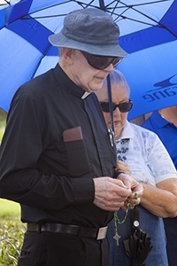 Father Dominick O'Dwyer, pastor of St. Malachy Church in Tamarac, leads the rosary during a ceremony commemorating the National Day of Remembrance for aborted children.