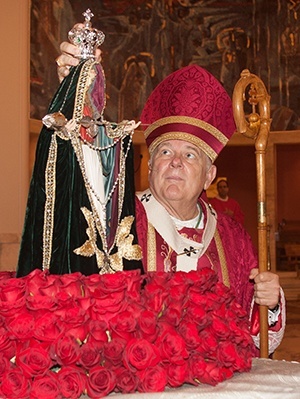 Archbishop Thomas Wenski crowns Our Lady Guardian of the Faith during a Mass in her honor.