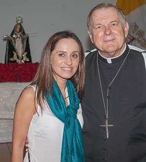 Archbishop Thomas Wenski poses for a photo with Pachi Talbot at a reception following Mass.
