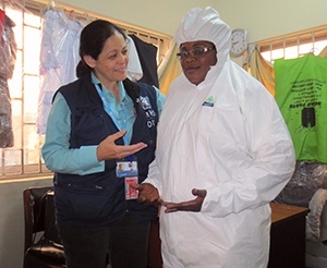 Dr.Aileen Marty at Tincan Seaport with Adebesin Modinay who was fully suited as a preventive for hazardous diseases like Ebola virus.