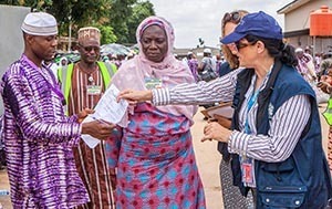 Dr. Aileen Marty (right) distributes forms to World Health Organization volunteers.