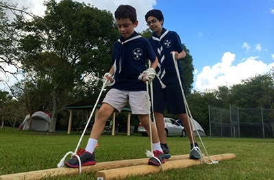 Timber Wolves Andres Jimenez and Jake Sivilla participate in a game requiring coordination and cooperation during a campout at Camp Owaissa Bauer in February 2014.