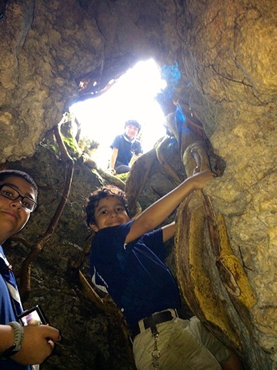 Explorer Leo Gonzalez, and Timber Wolves Christian Marmolejos and Luis Gonzalez explore a cave during the Stella Maris Explorers campout at Camp Owaissa Bauer in February 2014.