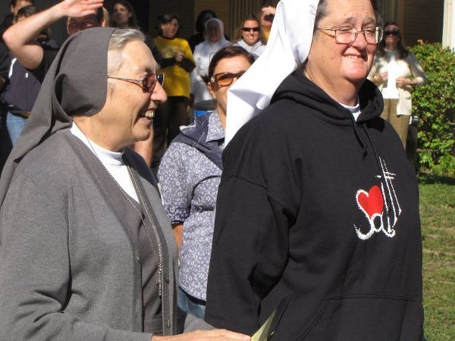 Mother Yvonne Reungoat, left, superior general of the Daughters of Mary Help of Christians (also known as Salesians of St. John Bosco), tours the campus of Immaculata-La Salle High School in Miami with the school's principal, Sister Patricia Roche.
