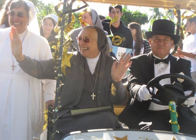 A tuxedo-clad Humberto Perez drives Mother Yvonne Reungoat around the campus of Immaculata-La Salle High School Nov. 13. Next to them is Sister Theresa Gutierrez. Mother Reungoat is her order's general superior.