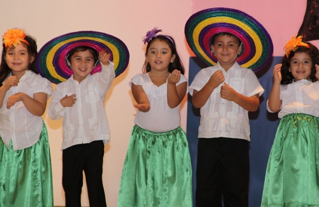 Blessed Trinity PK-4 students dance and sing the "Guacamole song" during Noche de Hispanidad celebration. 

Pictured from left to right Brianna Howard, Ethan Amor, Lourdes Martinez,Jared Martinez and Sofia Lopez.