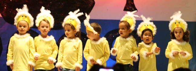 Blessed Trinity PK-3 students dance and sing "The Pollito Song" during Noche de Hispanidad celebration.