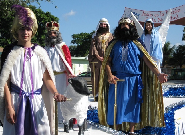 St. Brendan High School students Tony Lopez, Rey Leal, Juan Menache, Frank Ortiz and Miriam Arias pose atop the Radio Paz float as it makes its way through the streets of Hialeah.